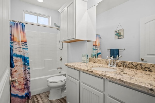 full bathroom with shower / bath combination with curtain, toilet, vanity, and hardwood / wood-style flooring