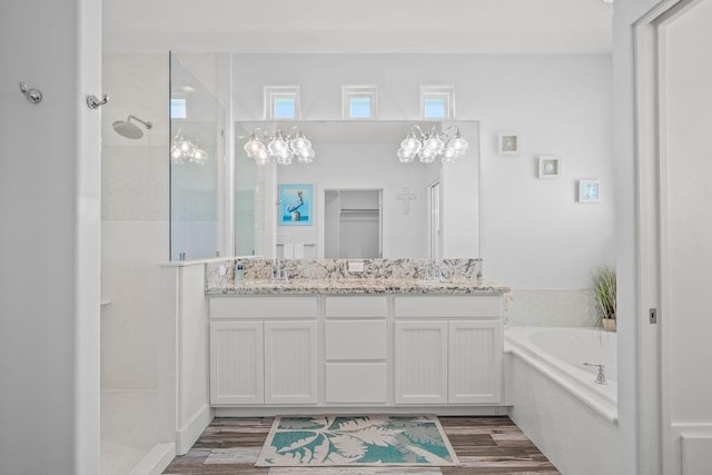 bathroom featuring vanity, hardwood / wood-style floors, and independent shower and bath