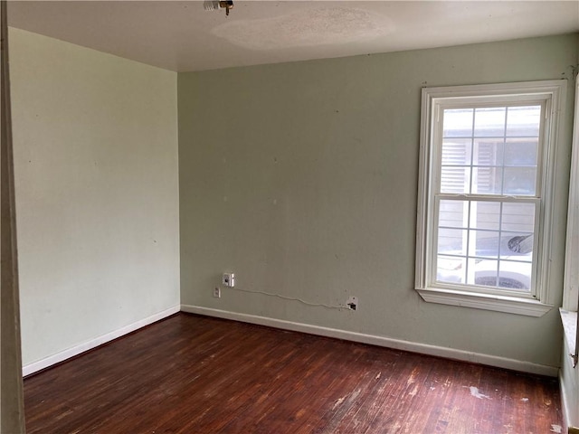 unfurnished room featuring dark wood-type flooring