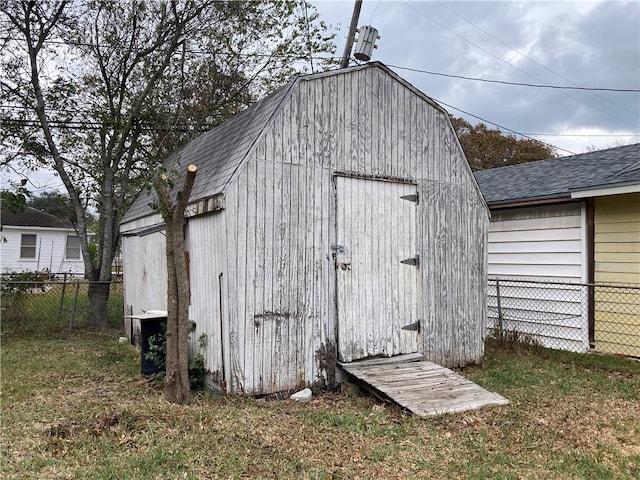 view of outbuilding featuring a lawn