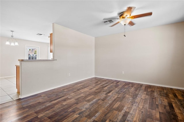 1522 W Nelson Ave, Aransas Pass, TX 78336 - unfurnished room featuring ceiling fan, a chandelier, wood finished floors, and baseboards