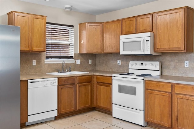 1522 W Nelson Ave, Aransas Pass, TX 78336 - kitchen featuring white appliances, a sink, light countertops, tasteful backsplash, and light tile patterned floors