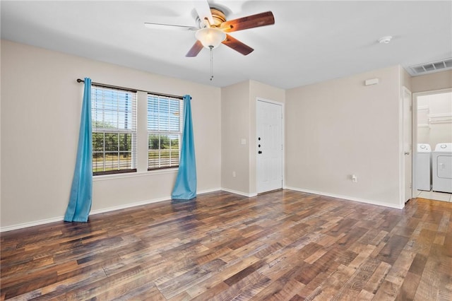 1522 W Nelson Ave, Aransas Pass, TX 78336 - spare room with washer and clothes dryer, a ceiling fan, wood finished floors, and baseboards