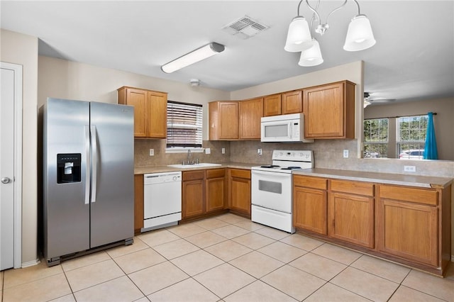 1522 W Nelson Ave, Aransas Pass, TX 78336 - kitchen with white appliances, backsplash, light countertops, and a peninsula