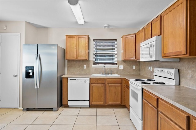 1522 W Nelson Ave, Aransas Pass, TX 78336 - kitchen featuring white appliances, a sink, light countertops, decorative backsplash, and light tile patterned floors