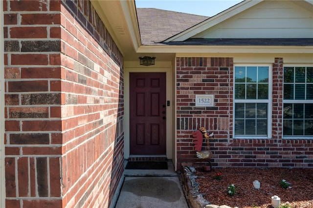 1522 W Nelson Ave, Aransas Pass, TX 78336 - doorway to property with brick siding and a shingled roof