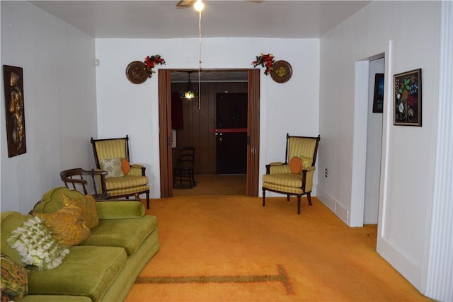 living room featuring a ceiling fan and carpet floors
