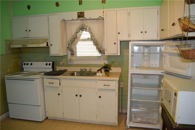kitchen with a sink, white cabinetry, under cabinet range hood, and white electric stove