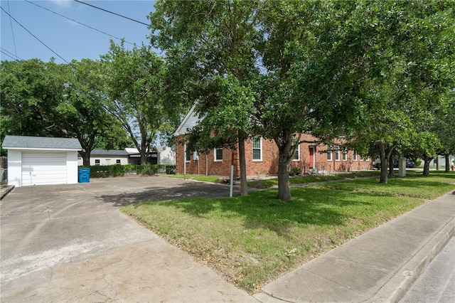 view of front of house featuring an outbuilding, a front lawn, and a garage