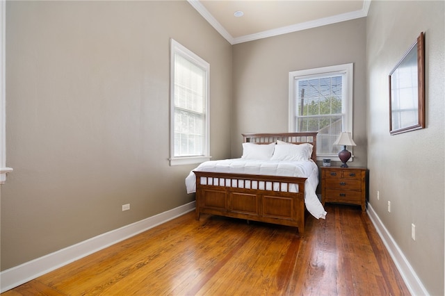 bedroom with wood-type flooring and ornamental molding