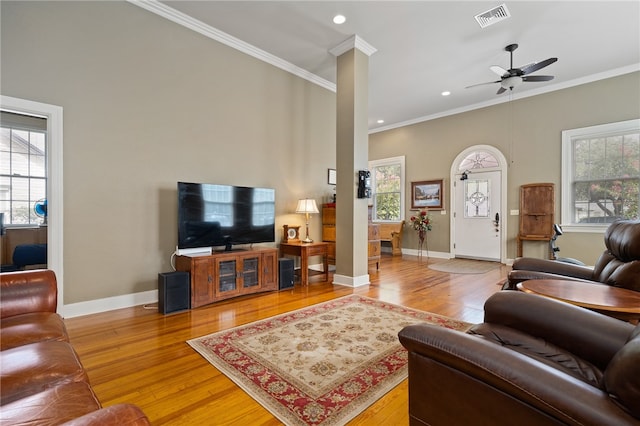 living room featuring wood-type flooring, ornate columns, a wealth of natural light, and ceiling fan