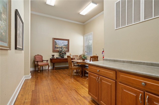 office area featuring crown molding and light hardwood / wood-style floors