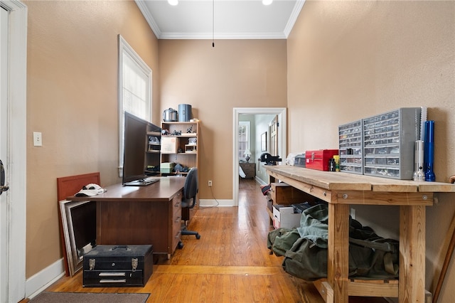 home office featuring hardwood / wood-style floors and ornamental molding