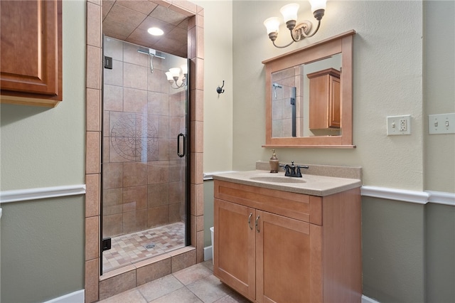 bathroom featuring tile patterned flooring, vanity, and a shower with door