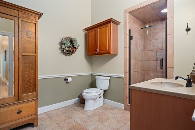 bathroom with tile patterned flooring, vanity, an enclosed shower, and toilet