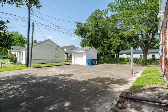 exterior space with a garage and an outbuilding