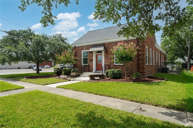 view of front of house with a front lawn and cooling unit