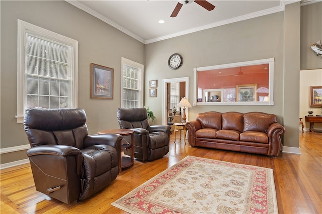 living room featuring hardwood / wood-style floors, ceiling fan, and ornamental molding