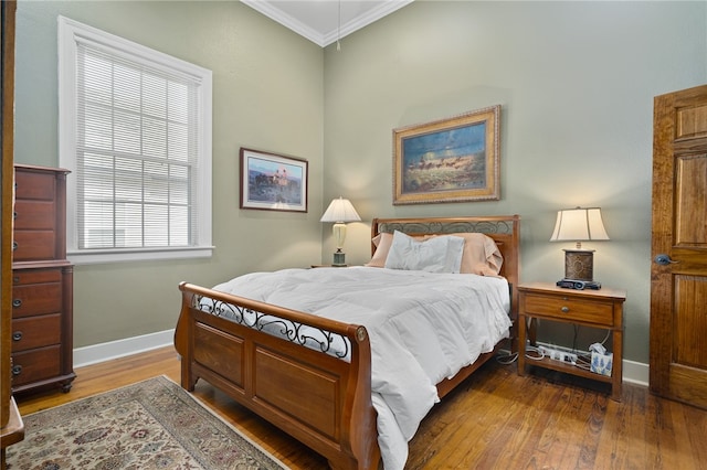 bedroom featuring hardwood / wood-style floors and ornamental molding