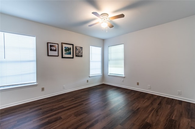 empty room featuring dark hardwood / wood-style flooring and ceiling fan