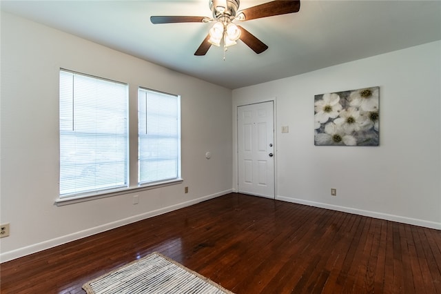 unfurnished room with dark hardwood / wood-style flooring and ceiling fan