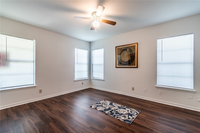 spare room featuring ceiling fan and dark hardwood / wood-style floors