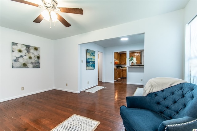 sitting room with dark hardwood / wood-style flooring and ceiling fan