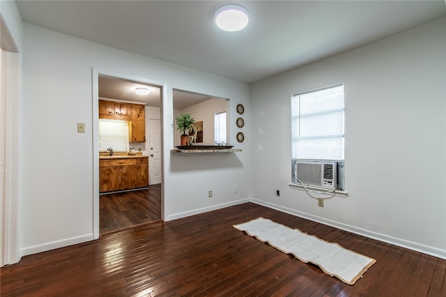 spare room with cooling unit, sink, and dark hardwood / wood-style floors