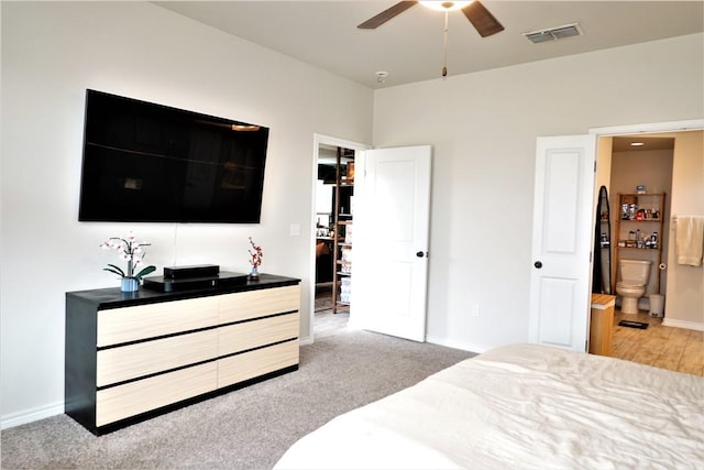 carpeted bedroom featuring ceiling fan and ensuite bathroom