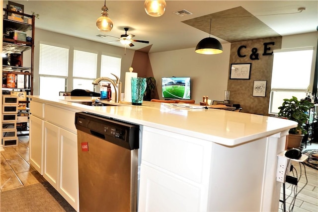 kitchen with pendant lighting, sink, white cabinets, a center island with sink, and stainless steel dishwasher