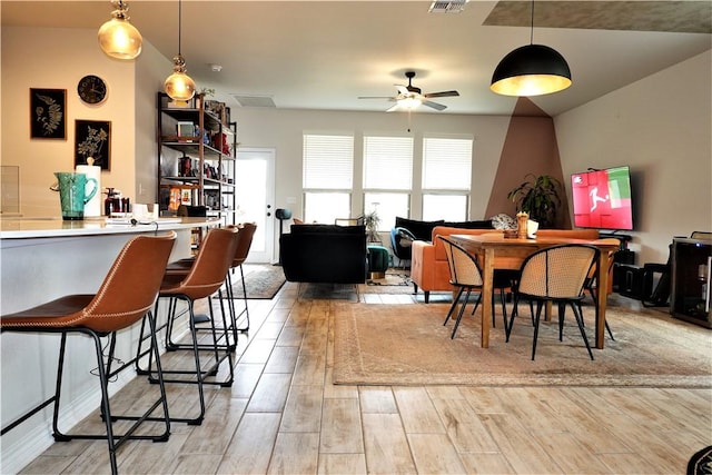 dining space featuring ceiling fan and light wood-type flooring