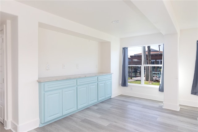 unfurnished dining area featuring light wood-type flooring