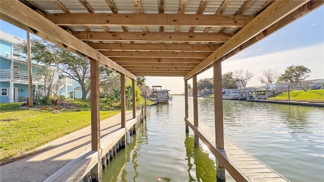 dock area featuring a water view and a yard