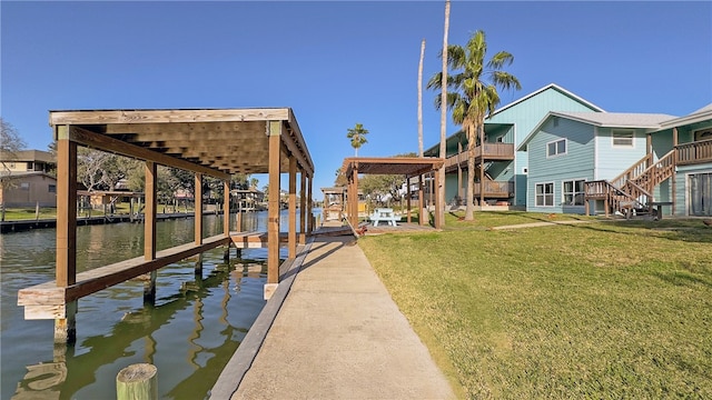 view of dock featuring a yard and a water view