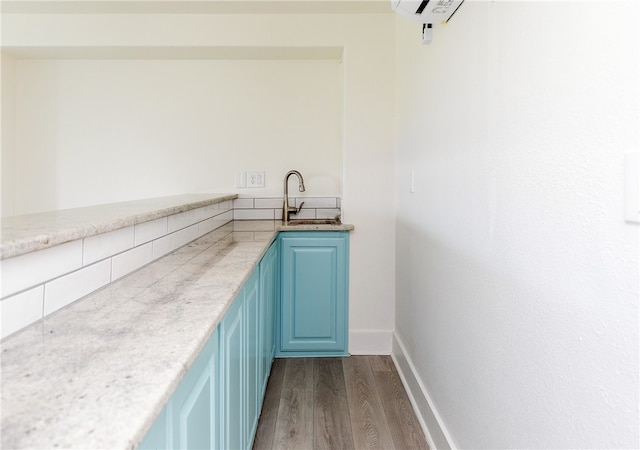 interior space featuring dark hardwood / wood-style floors, sink, and blue cabinets