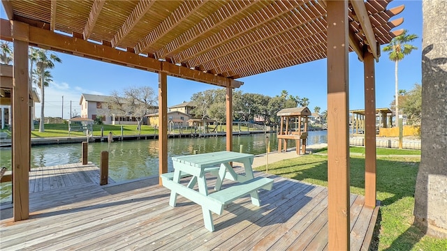 view of dock with a water view and a yard