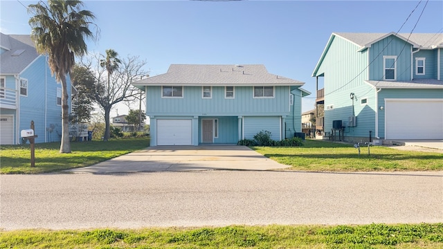 front of property with a front lawn and a garage