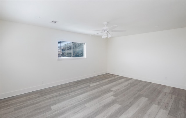 spare room featuring ceiling fan and light hardwood / wood-style floors