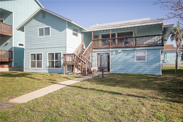 back of property with a balcony and a yard