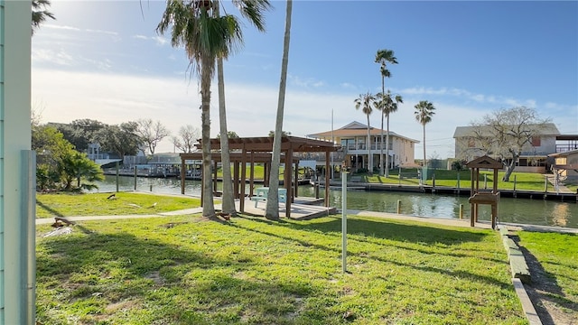 dock area with a water view and a lawn