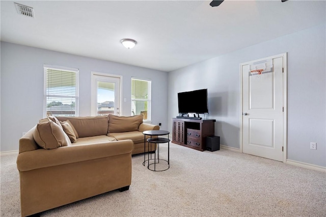 living room with carpet floors, visible vents, and baseboards