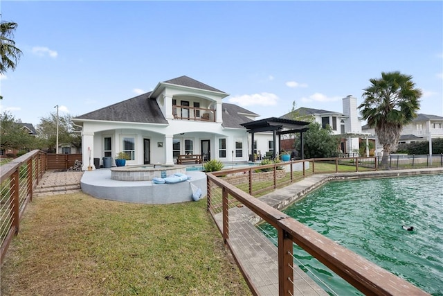 rear view of house with a fenced in pool, a lawn, a balcony, a fenced backyard, and a patio area