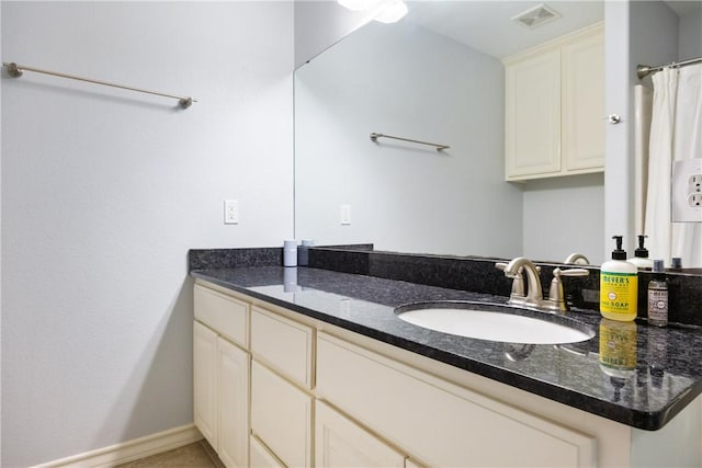 full bath with vanity, visible vents, and baseboards