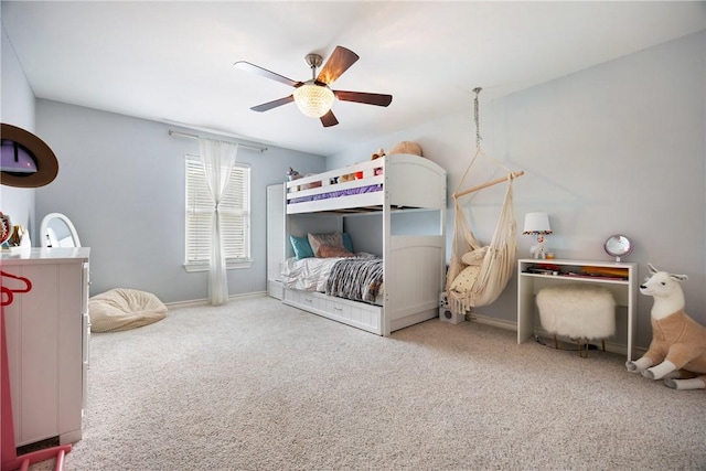 carpeted bedroom with baseboards and a ceiling fan