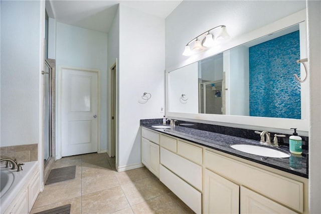 full bathroom with double vanity, tile patterned floors, a sink, and a shower stall