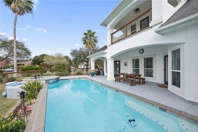 view of swimming pool with a patio area and a pool with connected hot tub