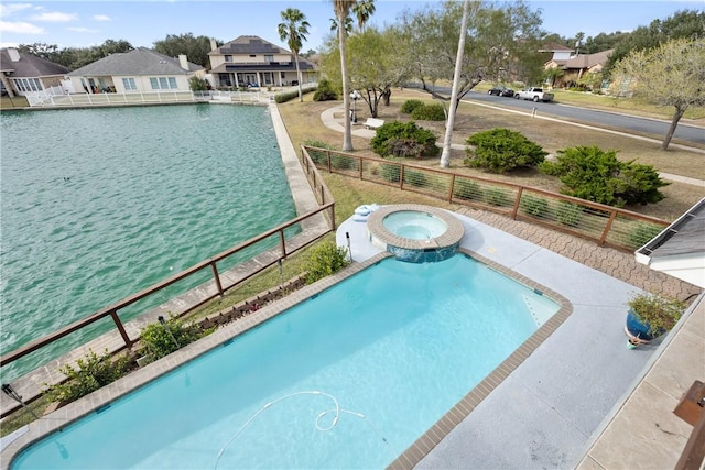 view of pool featuring a water view, fence, a fenced in pool, and an in ground hot tub