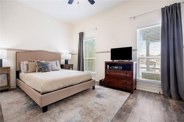 bedroom featuring multiple windows, a ceiling fan, and hardwood / wood-style floors