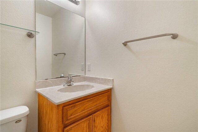 bathroom with toilet and vanity