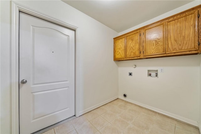 washroom with light tile patterned floors, baseboards, cabinet space, electric dryer hookup, and washer hookup